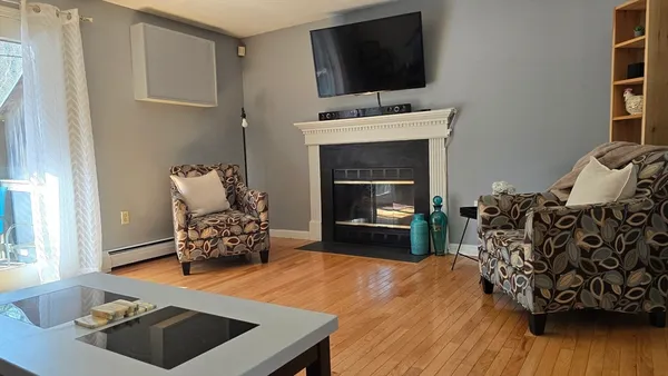 a living room with furniture and a fireplace