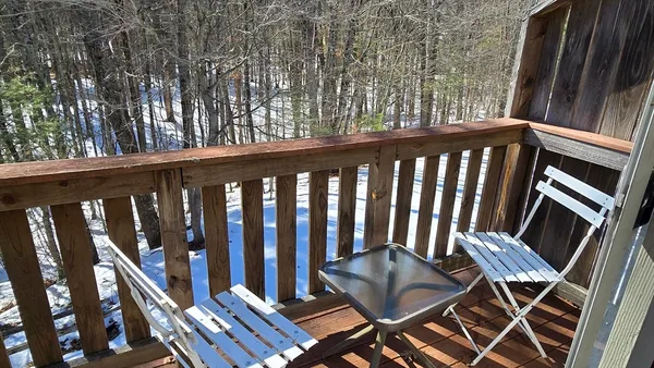 a view of a balcony with chairs