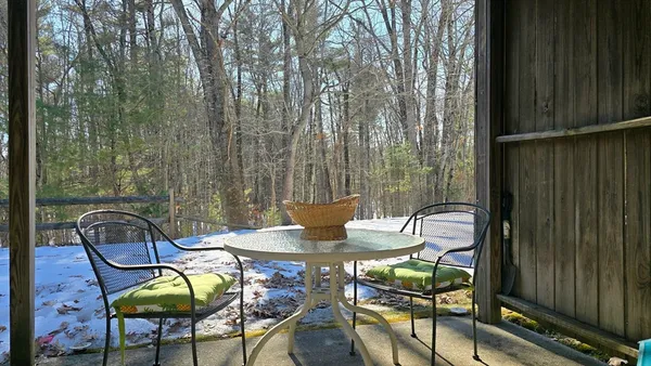 a view of a chairs and table in the balcony