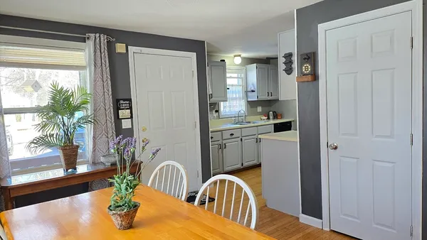 a kitchen with a refrigerator a sink and a table