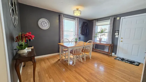 a view of a dining room with furniture and a window