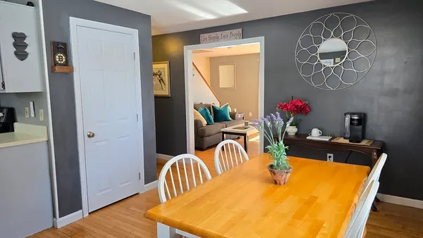 a view of a dining room with furniture wooden floor and a chandelier