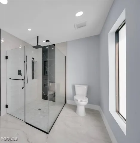 a bathroom with a shower and a toilet