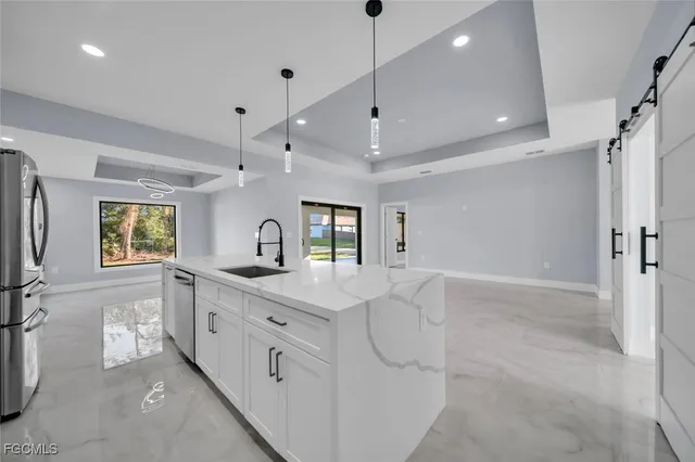 a large white kitchen with a large window