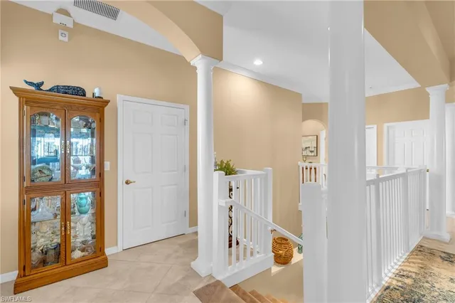 a living room with furniture a chandelier and a large window