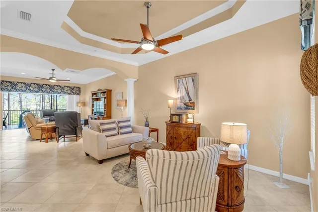 a living room with furniture a ceiling fan and a rug