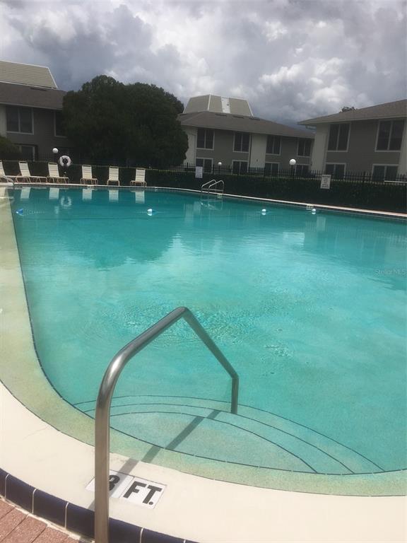1935 South Conway Road, Unit D1 Orlando, FL 32812 - Photo 19 of 21 a swimming pool with outdoor seating and yard