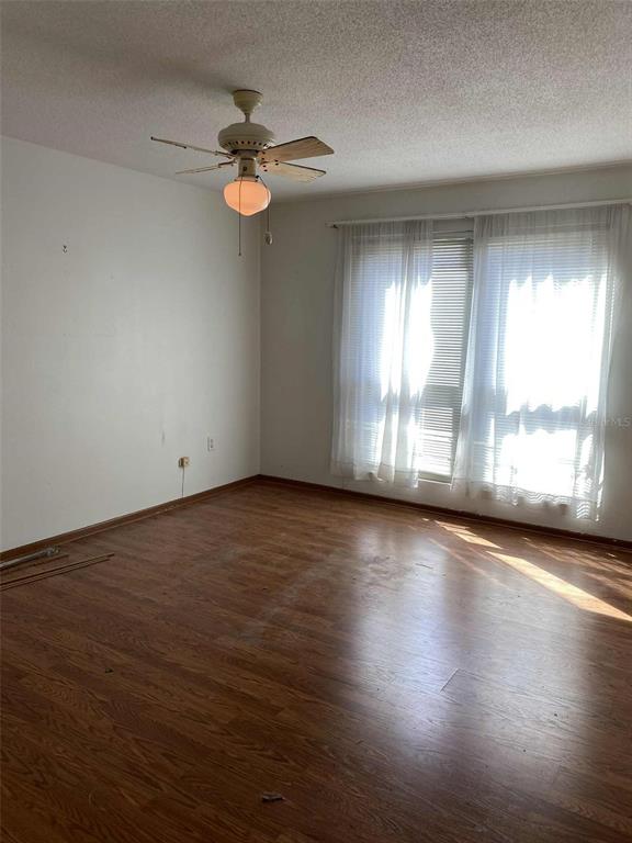 1935 South Conway Road, Unit D1 Orlando, FL 32812 - Photo 9 of 21 an empty room with wooden floor and windows
