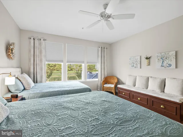 a bedroom with a bed and a lamp on dresser