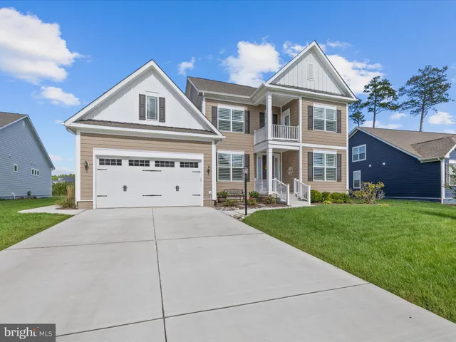a view of a dining room with furniture large windows and wooden floor