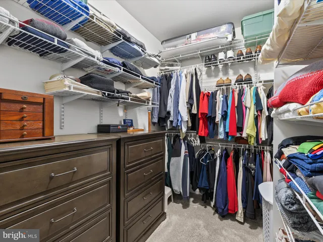 a living room with patio furniture and a potted plant