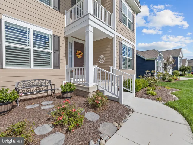 a view of a dining room with furniture wooden floor and chandelier