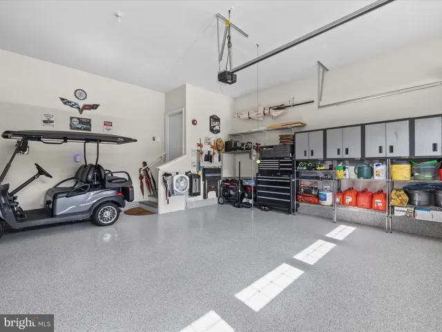 a living room filled with furniture and large windows