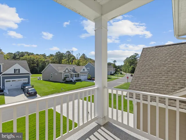 a living room with patio furniture and a large window