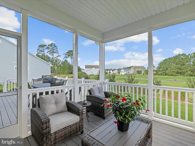 a sign board with a play ground in the back