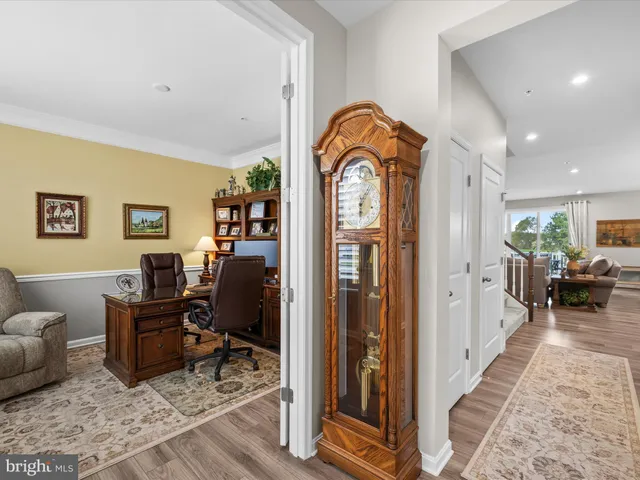 a dining room with furniture a chandelier and wooden floor