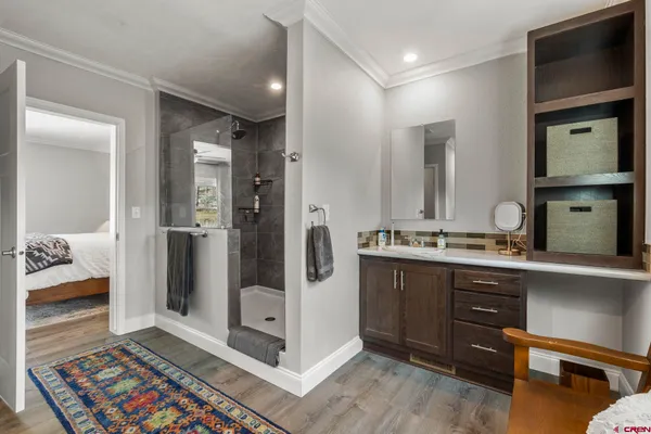 a bedroom with a bed and glass walk in closet