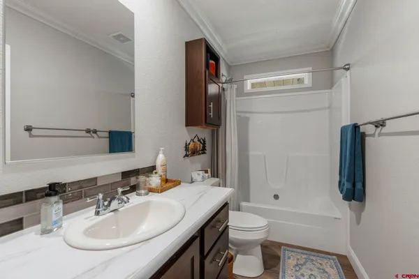 a front view of a house with a yard covered with snow in the background