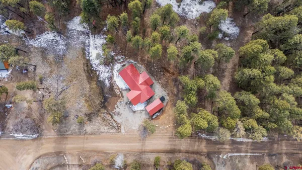 a view of a porch with wooden floor and outdoor seating