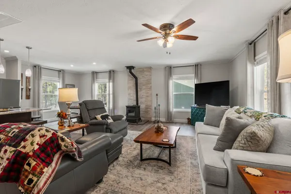 a view of a livingroom with furniture wooden floor and window