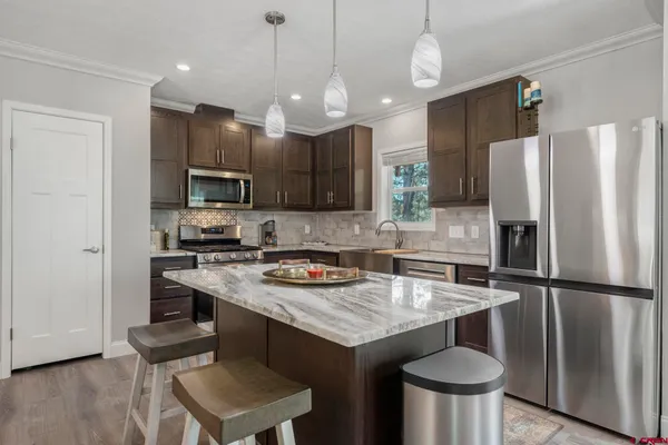 a living room with furniture a dining table and kitchen view
