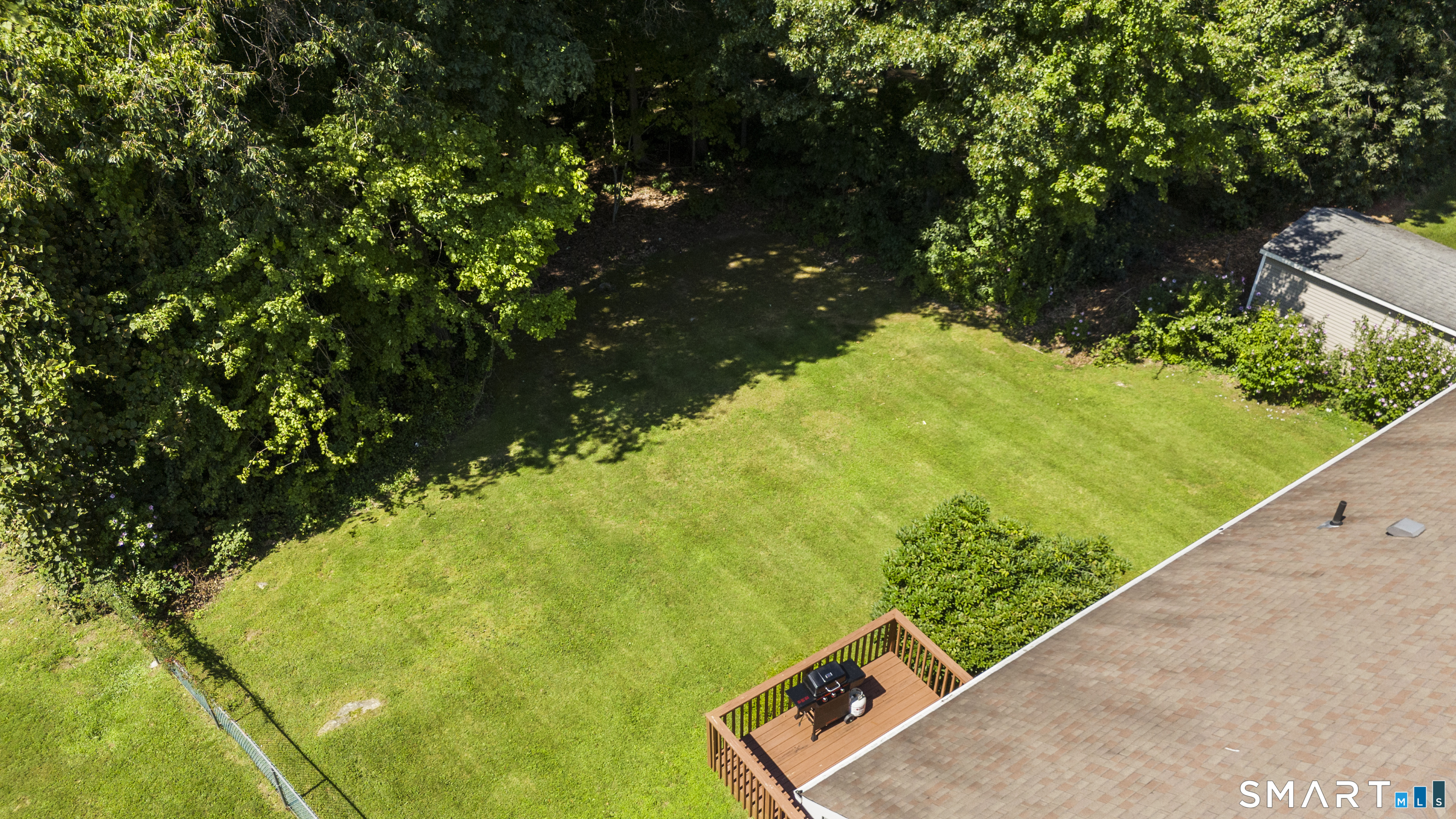 Private flat backyard with wooded area in the back