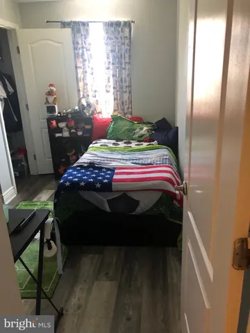 a bedroom with a bed next to a window