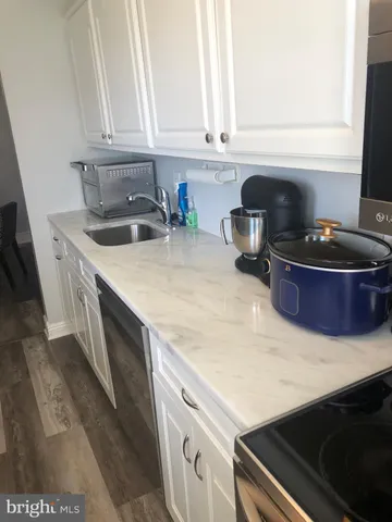 a kitchen with a stove and a white cabinets