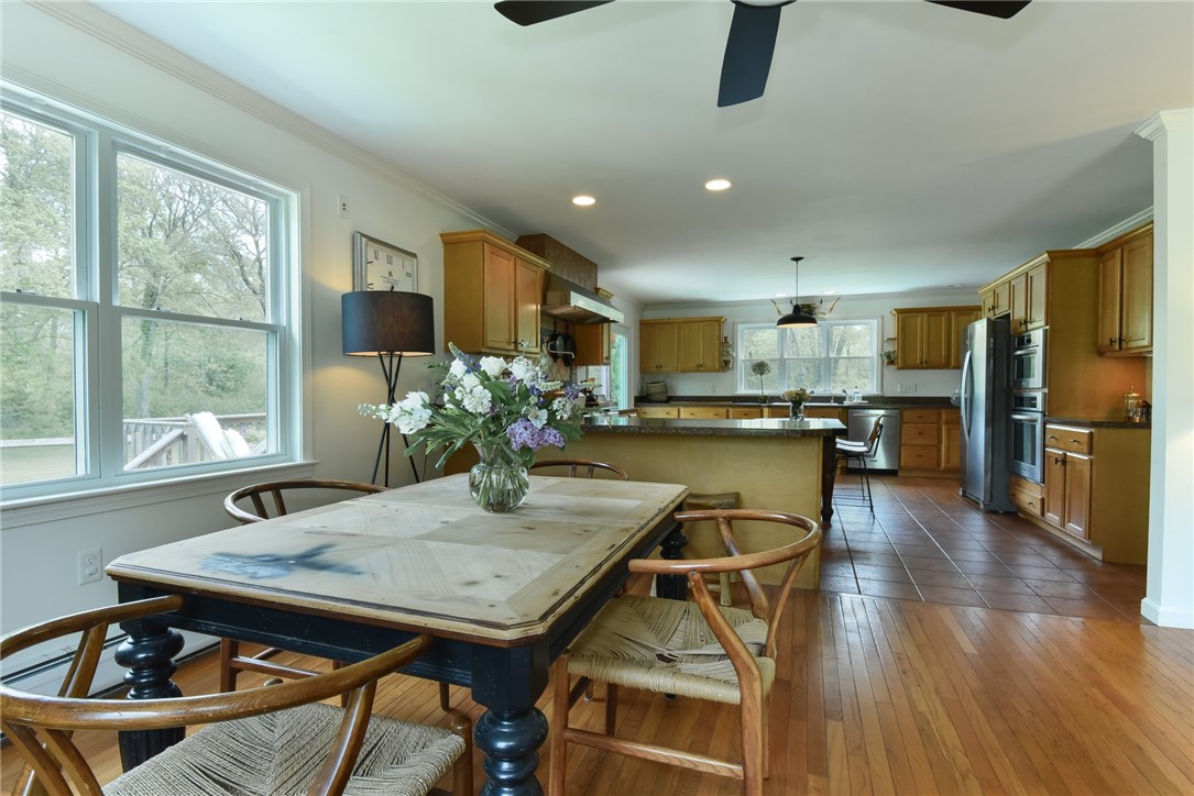 16 Biscuit City Road Richmond, RI 02836 - Photo 6 of 39 The dining area has wonderful windows and a peninsula bar, perfect for entertaining and open-concept living.