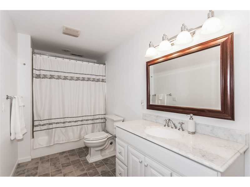 8 Milton Place Rowayton, CT 06853 - Photo 13 of 20 a bathroom with a granite countertop sink a toilet and a mirror