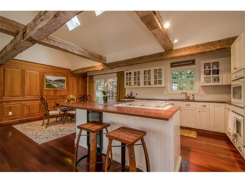 8 Milton Place Rowayton, CT 06853 - Photo 7 of 20 a kitchen with kitchen island wooden cabinets and dining table