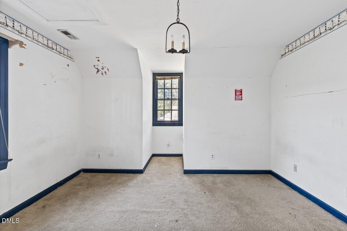 3812 Providence Road Rocky Mount, NC 27803 - Photo 11 of 18 a view of an empty room with wooden floor and windows