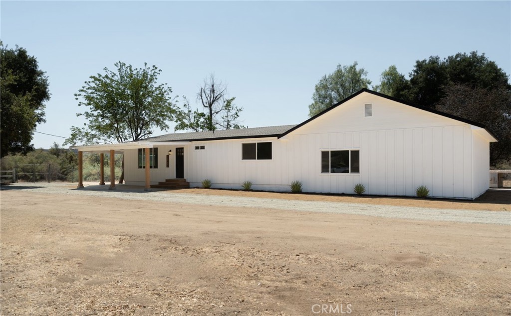 37455 Quarter Valley Road Temecula, CA 92592 - Photo 21 of 64 a front view of a house with a yard and garage