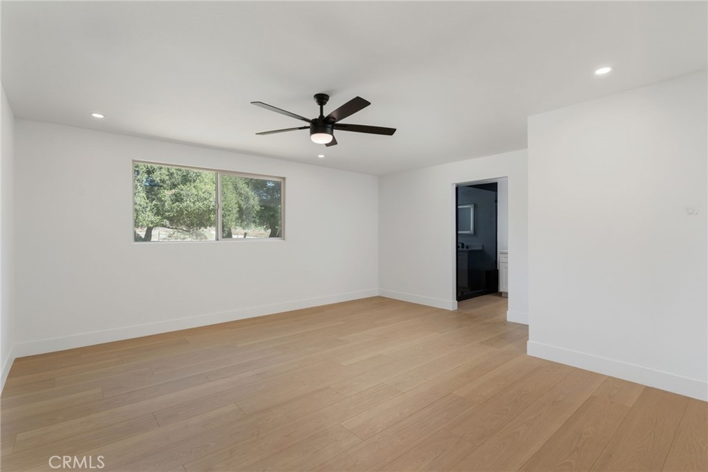 37455 Quarter Valley Road Temecula, CA 92592 - Photo 52 of 64 an empty room with windows and a ceiling fan