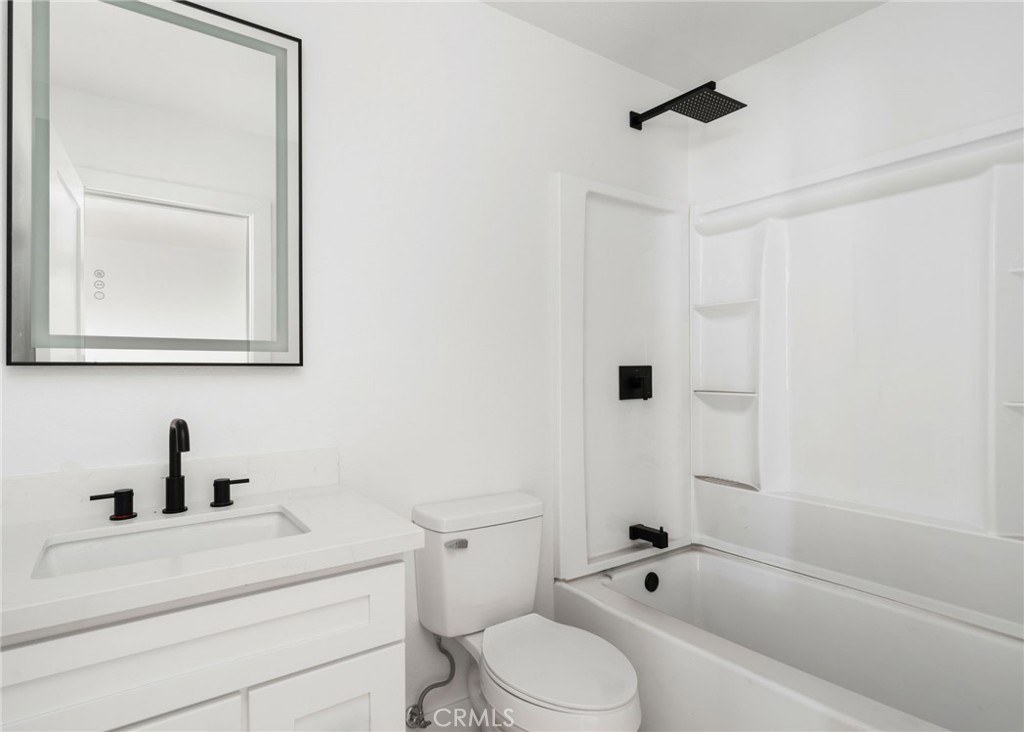 37455 Quarter Valley Road Temecula, CA 92592 - Photo 59 of 64 a bathroom with a bathtub shower sink vanity mirror and toilet