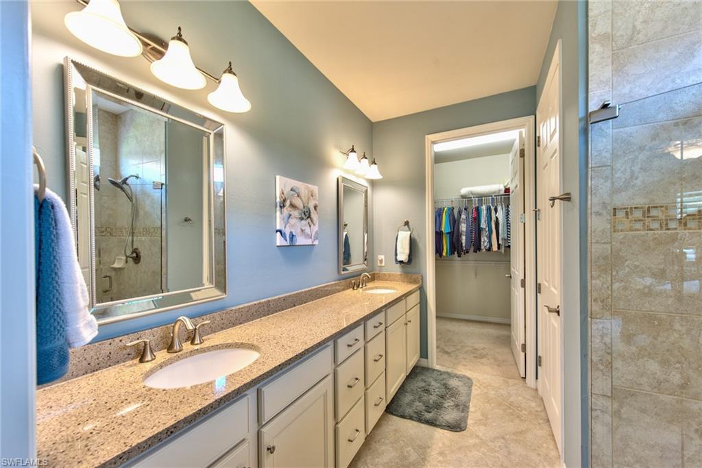 10910 Dennington Road Fort Myers, FL 33913 - Photo 13 of 25 a spacious bathroom with a sink and a mirror