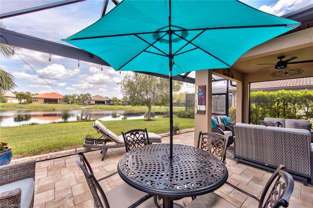 10910 Dennington Road Fort Myers, FL 33913 - Photo 5 of 25 a view of a patio with a table chairs and a umbrella