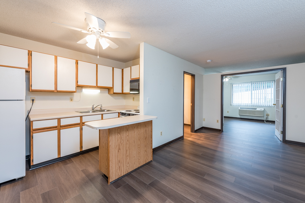 3305 Sunset Avenue, Unit 126 Waukegan, IL 60087 - Photo 7 of 20 a kitchen with stainless steel appliances granite countertop hardwood floor sink stove and wooden cabinets