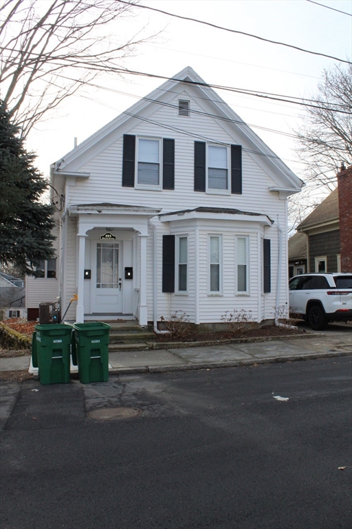 a front view of a house with a road
