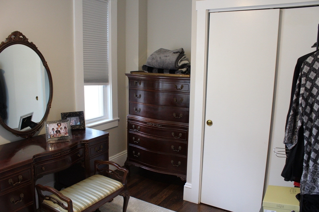 295 Haven Reading Ma, Unit 1 Reading, MA 01867 - Photo 14 of 16 a room with a chair and a mirror