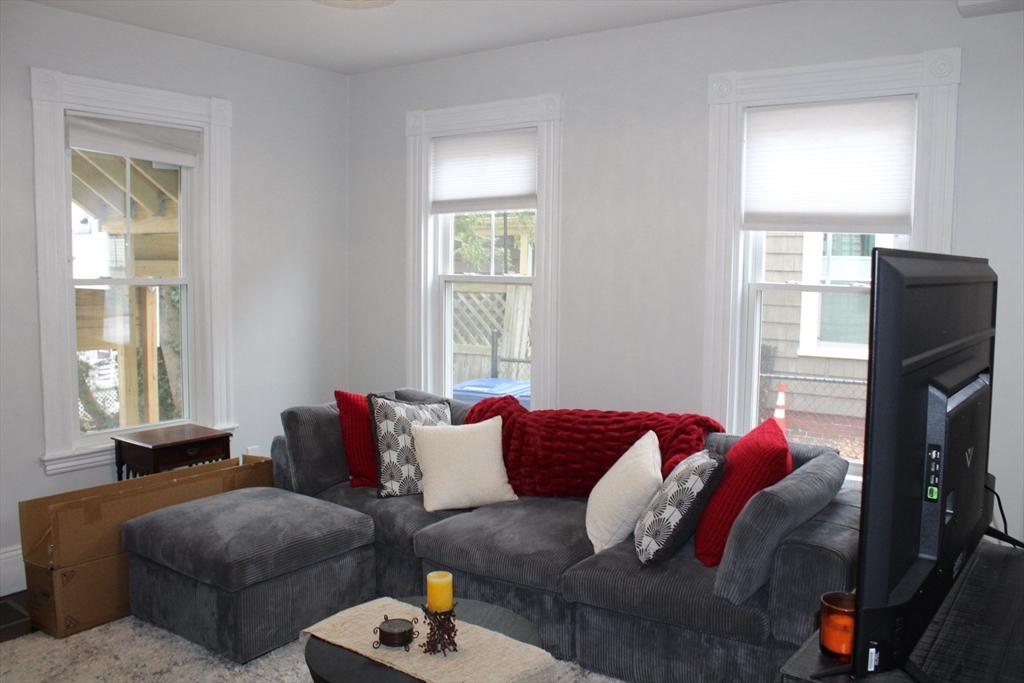 295 Haven Reading Ma, Unit 1 Reading, MA 01867 - Photo 5 of 16 a living room with furniture window and a flat screen tv