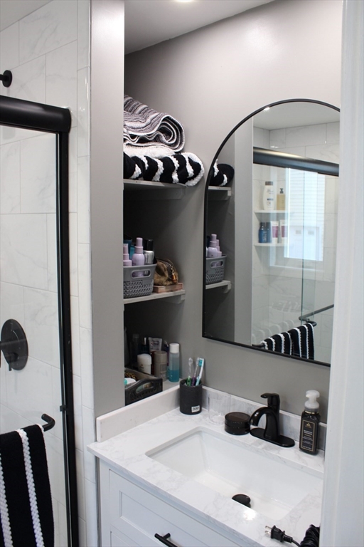 295 Haven Reading Ma, Unit 1 Reading, MA 01867 - Photo 7 of 16 a bathroom with a sink and a mirror