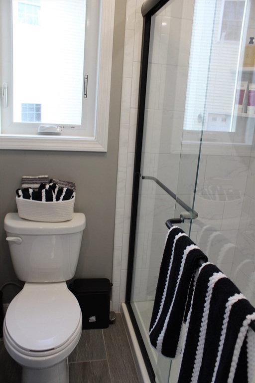295 Haven Reading Ma, Unit 1 Reading, MA 01867 - Photo 8 of 16 a bathroom with a toilet a sink and a window