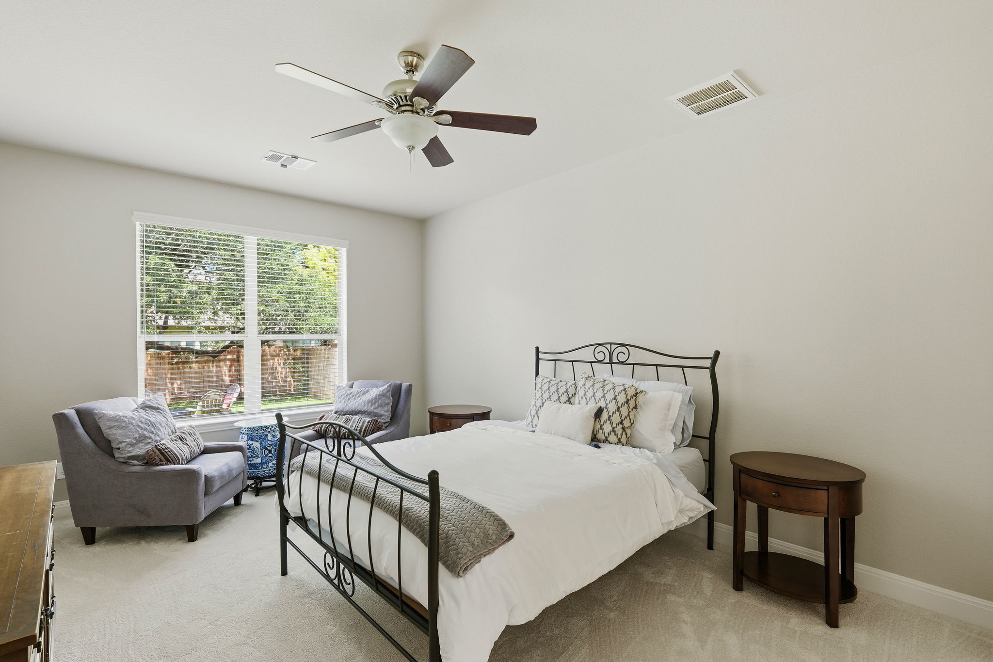 110 Dasher Drive Cedar Park, TX 78613 - Photo 15 of 39 A well-lit bedroom provides ample relaxation space with dual window views and soft carpeting.