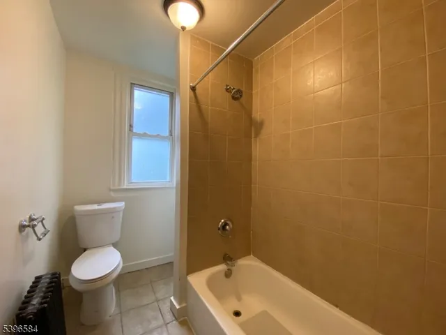 a bathroom with a toilet and shower