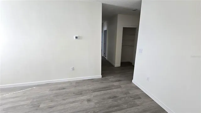 a view of a room with wooden floor