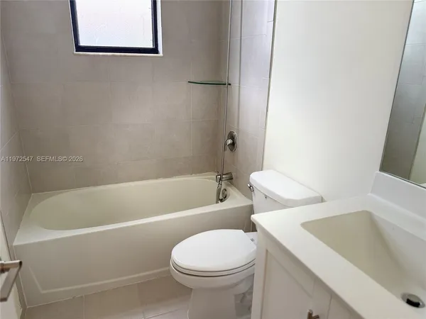 a bathroom with a toilet and a bathtub