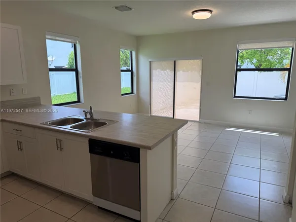a kitchen with a sink cabinets and window