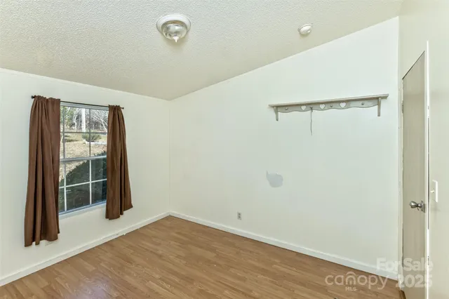 a view of a room with wooden floor