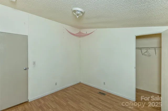 a bathroom with a granite countertop sink a mirror and a shower